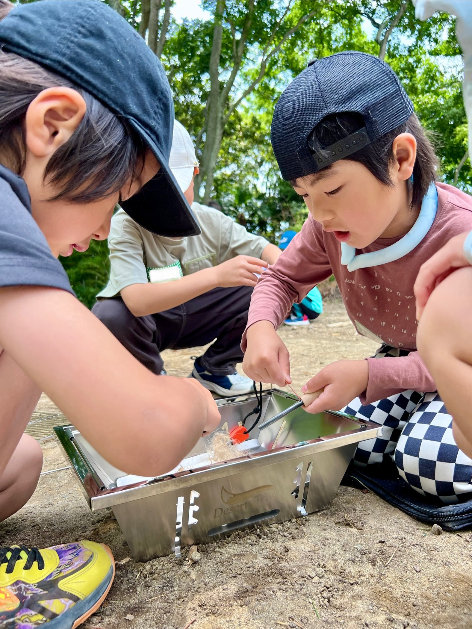 スターターを使って火おこしに挑戦する小学生｜四日市・菰野の週末体験型イベント