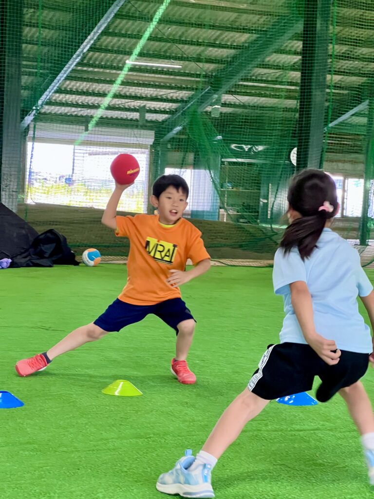 四日市の小学生がMiRAIのスポーツ教室でハンドボールシュートに挑戦する様子