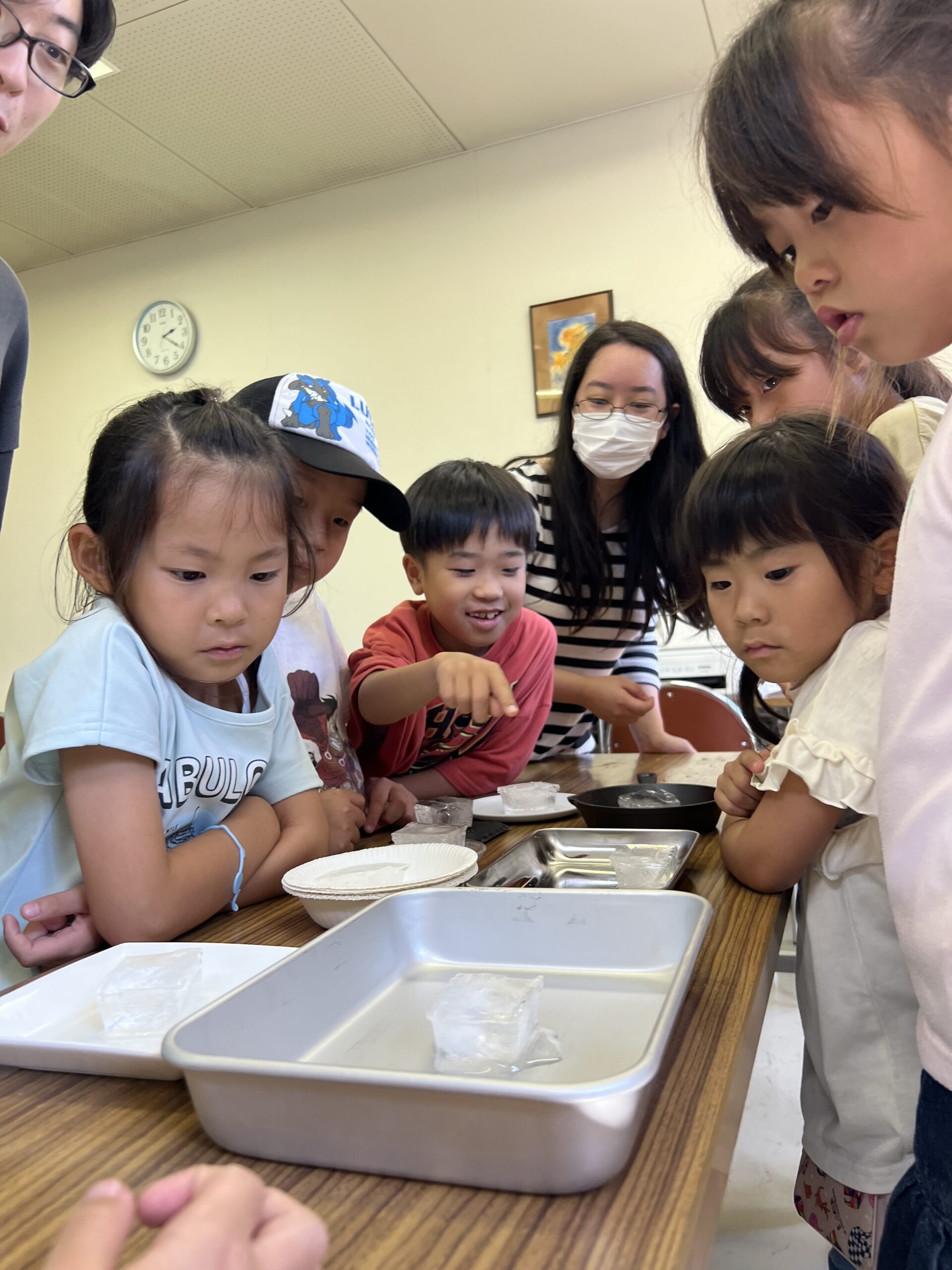 四日市で開催されたMiRAIサマスクで、子どもたちが理科の科学実験に挑戦し、氷の溶け方を楽しそうに観察・検証している様子。夏休みならではの体験学習を通じて科学への興味が育まれている瞬間。